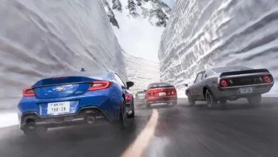 Cars racing through a snowy mountain pass, motion blur indicates speed.