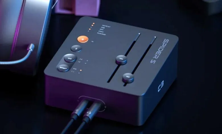 Fosi Audio Spider S3 audio interface with headphones, dark background.
