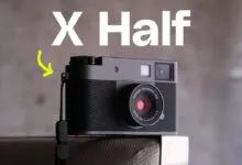 Fujifilm X Half camera with strap, gray body, and Fujinon lens.