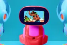 Toy robot with a screen showing a vintage cowboy cartoon scene.