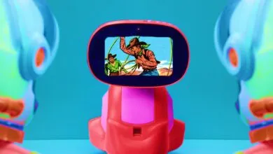 Toy robot with a screen showing a vintage cowboy cartoon scene.