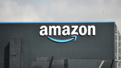 Amazon warehouse exterior with large white logo and blue smile arrow.