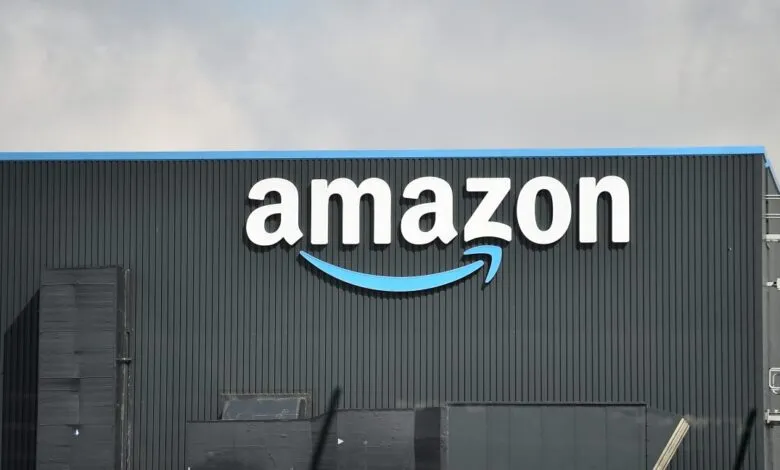 Amazon warehouse exterior with large white logo and blue smile arrow.
