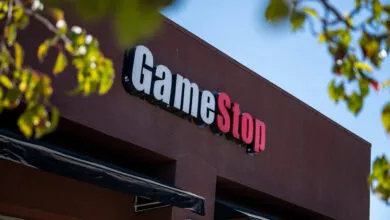 GameStop store exterior with white and red logo against a brown building.
