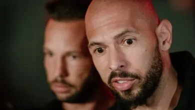 Close-up of Andrew Tate with brother Tristan in background.