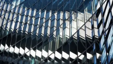 Abstract view of a glass building reflecting another structure.