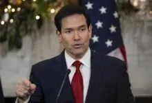 Marco Rubio speaks with American flag backdrop.