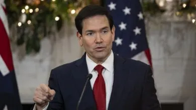 Marco Rubio speaks with American flag backdrop.