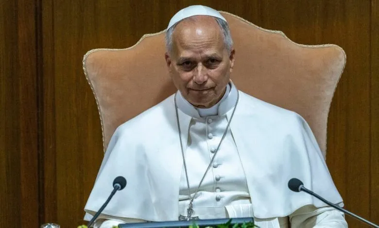 Archbishop Claudio Gugerotti seated, wearing white robes and zucchetto.