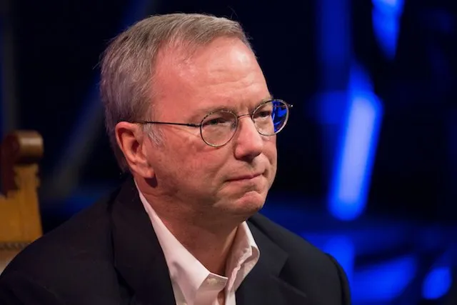 Eric Schmidt, former Google CEO, sits in a dark setting.