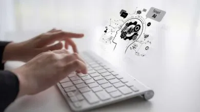 Hands typing on keyboard with AI brain graphic overlay.