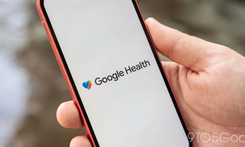 Google Health logo displayed on a red smartphone held in a hand.