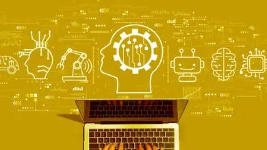 Laptop with AI icons: brain, robot, chip, head with gears on gold background.