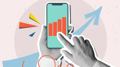 Hands holding phone with rising bar graph, indicating growth.