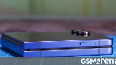 Folded blue smartphone showing hinge and SIM card slot.
