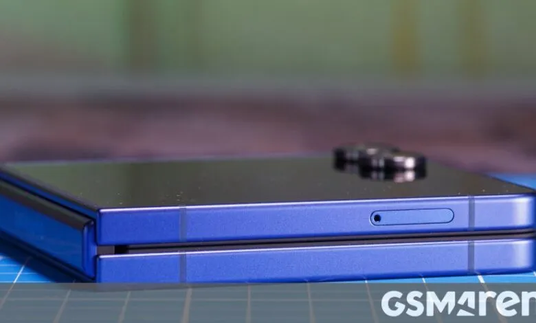 Folded blue smartphone showing hinge and SIM card slot.