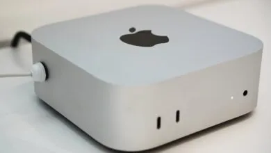 Silver Apple Mac Mini desktop computer on a white surface.
