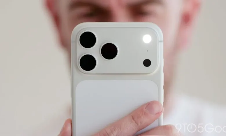 Close-up of a white smartphone camera with three lenses and flash.