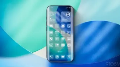 iPhone mockup showcasing iOS 26 with transparent app icons and widgets.