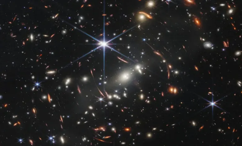 Deep field image showing numerous galaxies of varying shapes and colors.