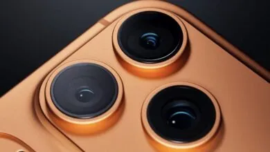 Close-up of a gold smartphone with three prominent camera lenses.