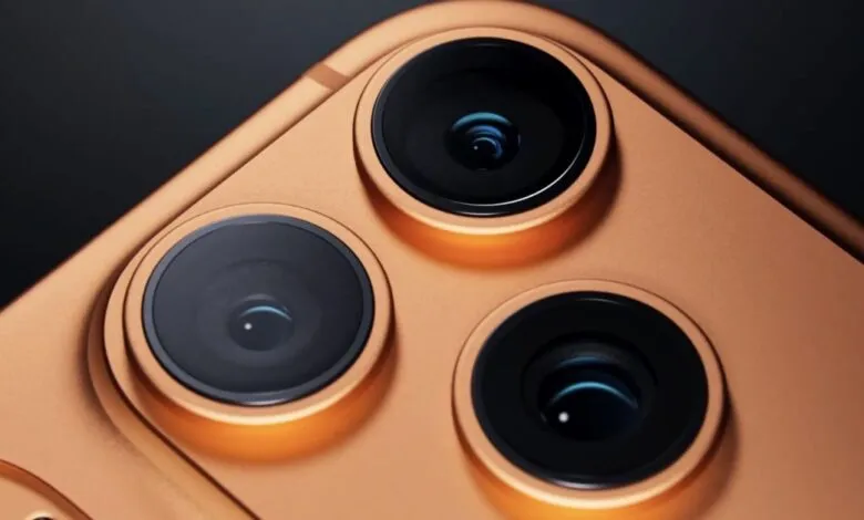 Close-up of a gold smartphone with three prominent camera lenses.