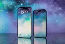 Two iPhones display a celestial-themed wallpaper on a reflective surface.
