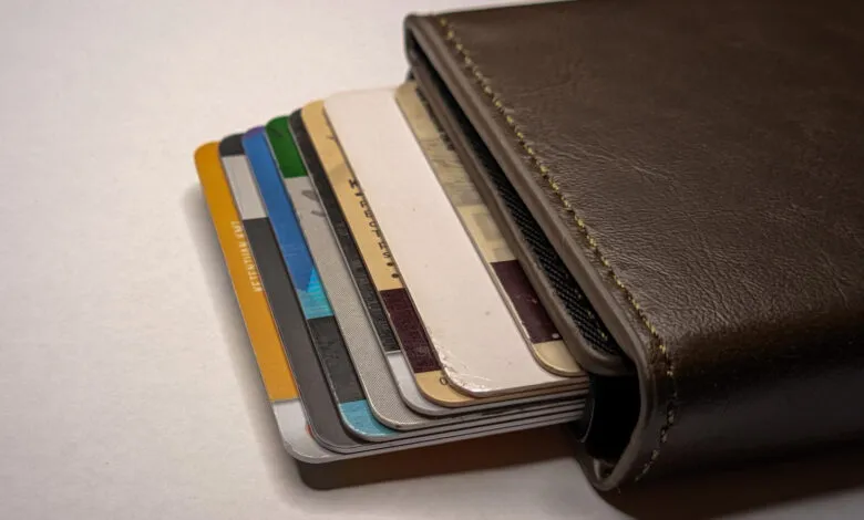 Brown leather wallet filled with various credit and debit cards.