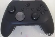 Close-up of a black Xbox Elite Series 2 controller on a white surface.