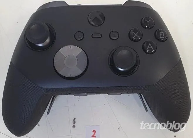 Close-up of a black Xbox Elite Series 2 controller on a white surface.
