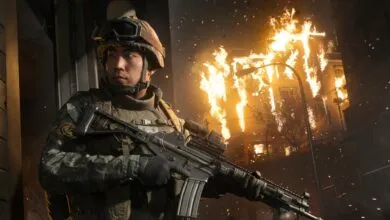 Soldier in combat gear stands guard against a burning building backdrop.