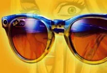 Close-up of Ray-Ban Meta smart glasses with a woman's face in the background.