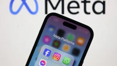 Meta Platforms apps displayed on a smartphone with the Meta logo in the background.