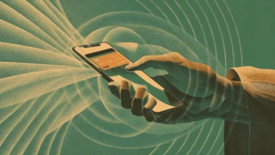 Hand holding phone with credit card on screen, digital payment.
