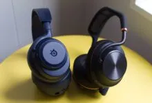 Two wireless gaming headsets, one blue SteelSeries, one black.