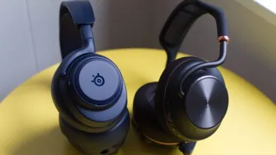 Two wireless gaming headsets, one blue SteelSeries, one black.