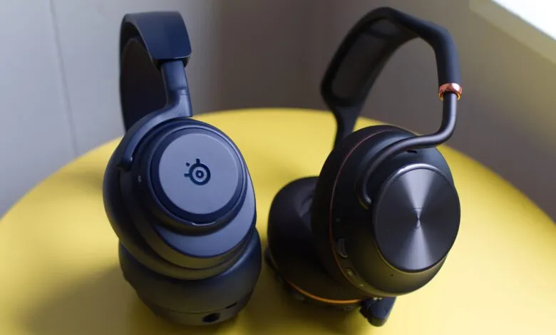 Two wireless gaming headsets, one blue SteelSeries, one black.