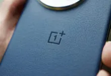 Close-up of a blue OnePlus phone with a textured back and logo.