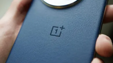 Close-up of a blue OnePlus phone with a textured back and logo.