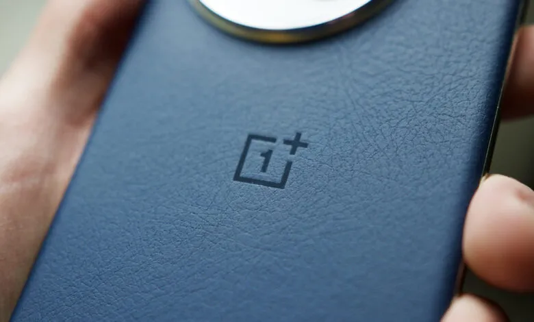 Close-up of a blue OnePlus phone with a textured back and logo.