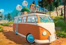 Orange and white camper van parked on a dirt road in a forest setting.
