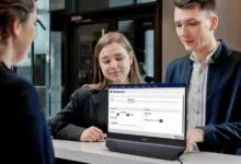 Hotel guests check in using a Philips display at the front desk.