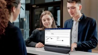 Hotel guests check in using a Philips display at the front desk.