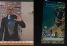 Man takes selfie with Pixel phone showing 'Pixel Ultra Meeting' notification.