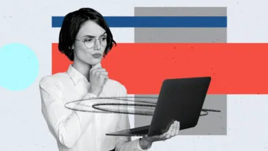 Woman in glasses thoughtfully holding laptop against abstract background.