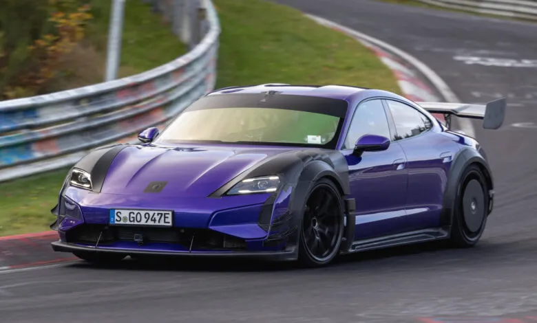 Purple Porsche Taycan Turbo GT with Manthey kit driving on a racetrack.