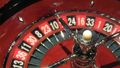Close-up of a roulette wheel with a ball on the center post.