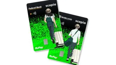 Two Scapia credit cards featuring travelers and QR code design.