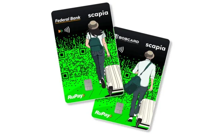 Two Scapia credit cards featuring travelers and QR code design.