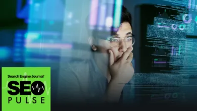 Man with glasses looking at computer screen with data and graphs.